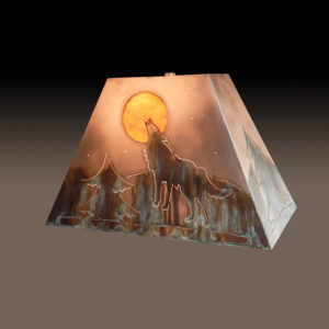 Copper Lamp Shade of Wolf Howling at the Moon under starry night. Evergreen with mountain in background. Sides of shade have ever green design.