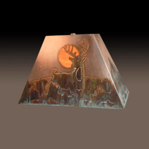 Copper Lamp Shade of Buck Deer in bushes under moon light. Ever Green tree design on the side of shade.